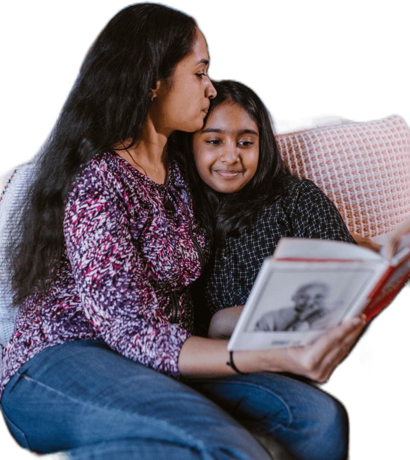 Mother and daughter reading together at home